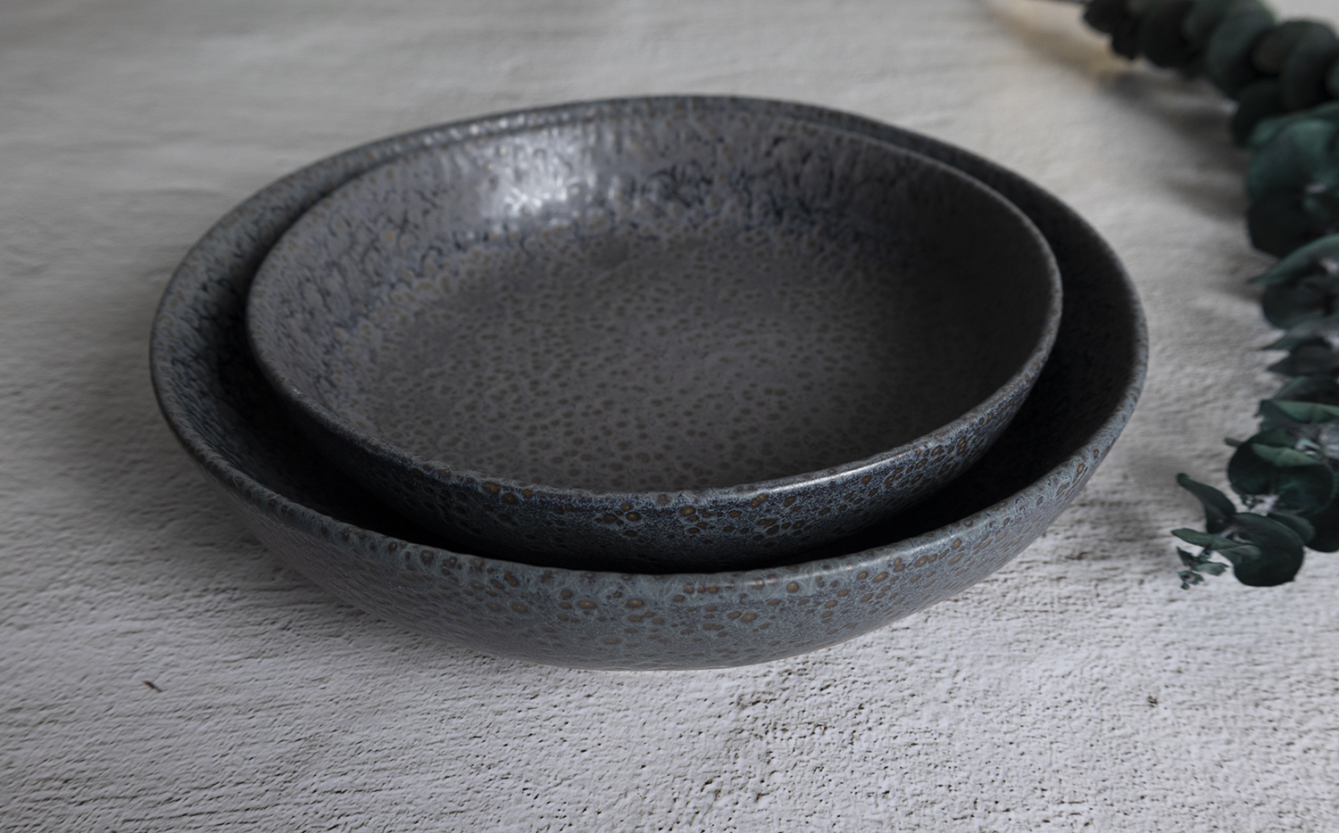 ​CHANGSHA HAPPY GO  Reactive Glaze Stoneware Collection in Charcoal Pebble Texture with Contemporary Look  |happygodinnerware.com