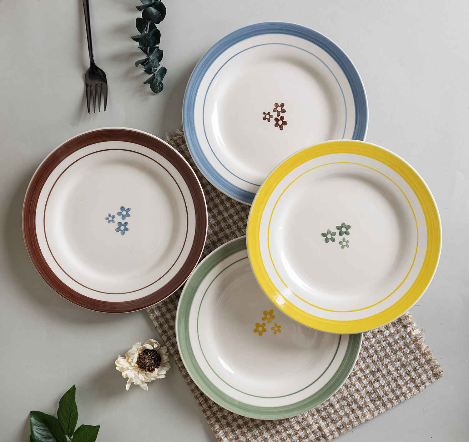 CHANGSHA HAPPY GO Fine Earthware Playful Dinnerware Set with Hand-Painted Colorful Small Flowers and Striped Accents  |happygodinnerware.com